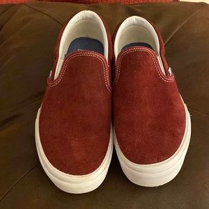 Burgundy platform slip on Vans sneakers.